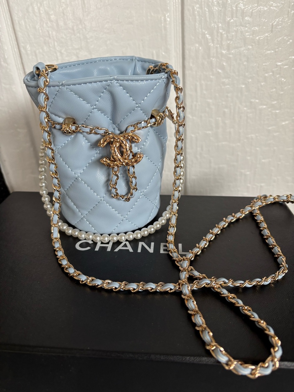 CHANEL Light Blue Quilted Mini Bucket Bag with Pearl Strap and Gold Chain